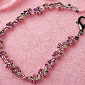Small pink bracelet made with pink flower beads and a lobster claw clasp.