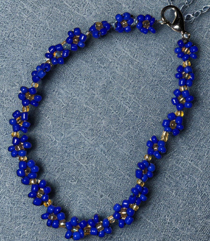Small bracelet made with navy flower beads and a lobster claw clasp.