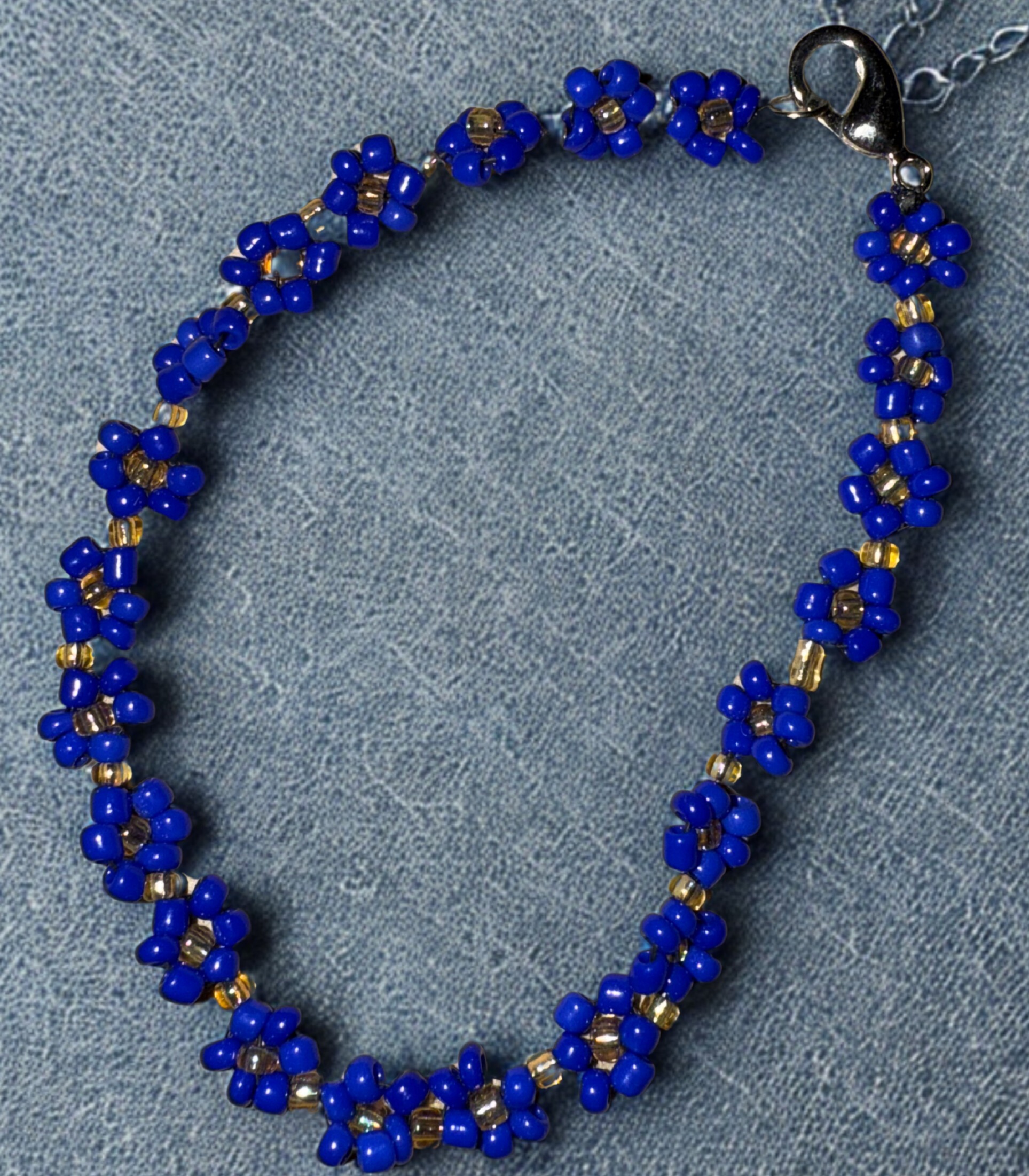 Small bracelet made with navy flower beads and a lobster claw clasp.