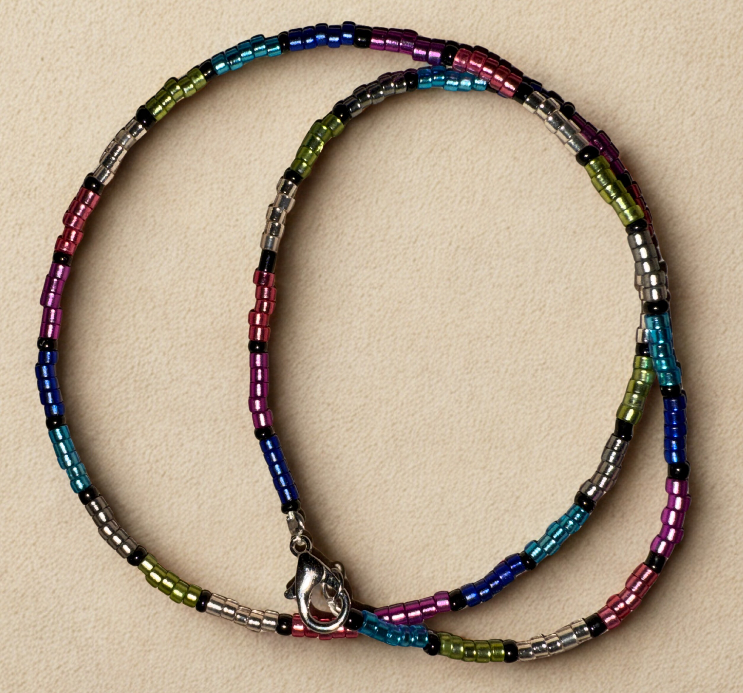 Medium length necklace, 16 inches with multicolored and black beading and a lobster claw clasp.