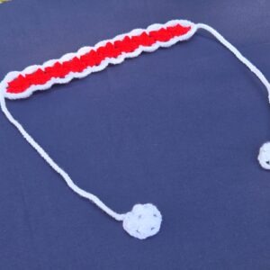 Red and white crochet headband. Band 12 1/2 inches long, 2 inches wide. Straps approx. 14 inches long, featuring white detailed crochet on the ends.