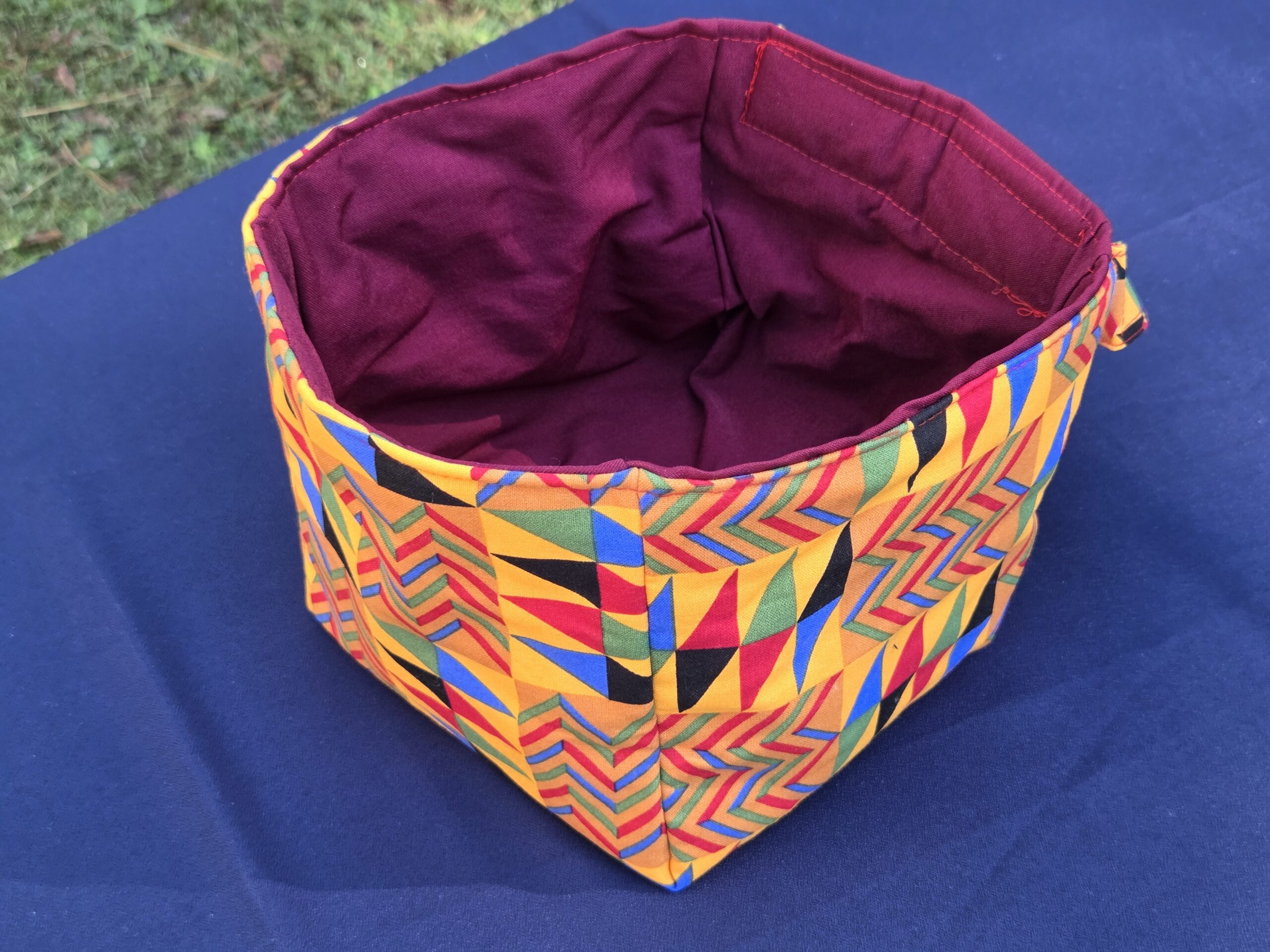 Car organizer and trash bin. Jeweltones. Both have straps. Organizer features main pocket, 2 front pockets, and a hidden zipper pocket in back. Trash bin strap features hook & loop strap.