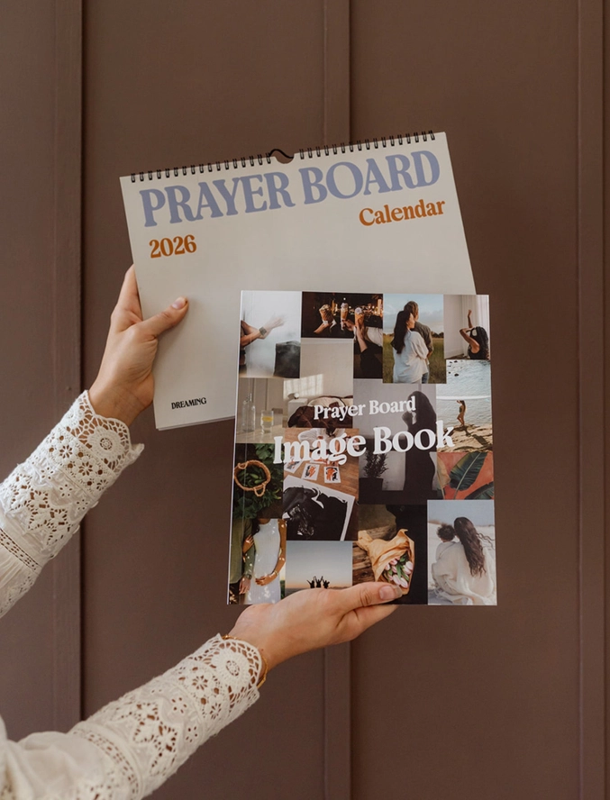 Hands holding Prayer Board Calendar and Image Book