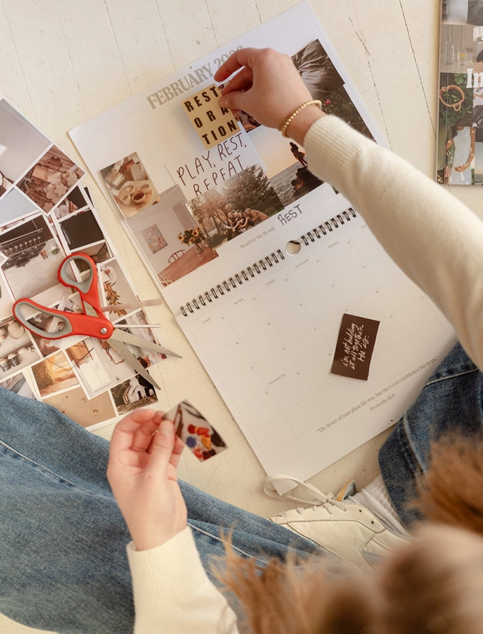 Woman placing image into prayer calendar