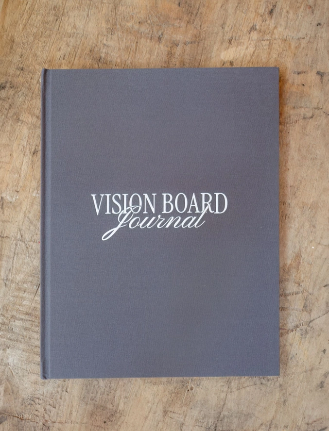 the hardback vision board journal book sitting on a desk