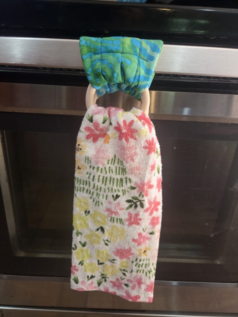 Blue-green, teal kitchen towel hanger turns any kitchen towel into a hanging towel
