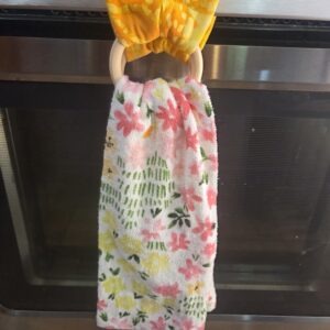 Towel hanger turns any kitchen towel into a hanging towel for the stove, dishwasher, or drawer handles.