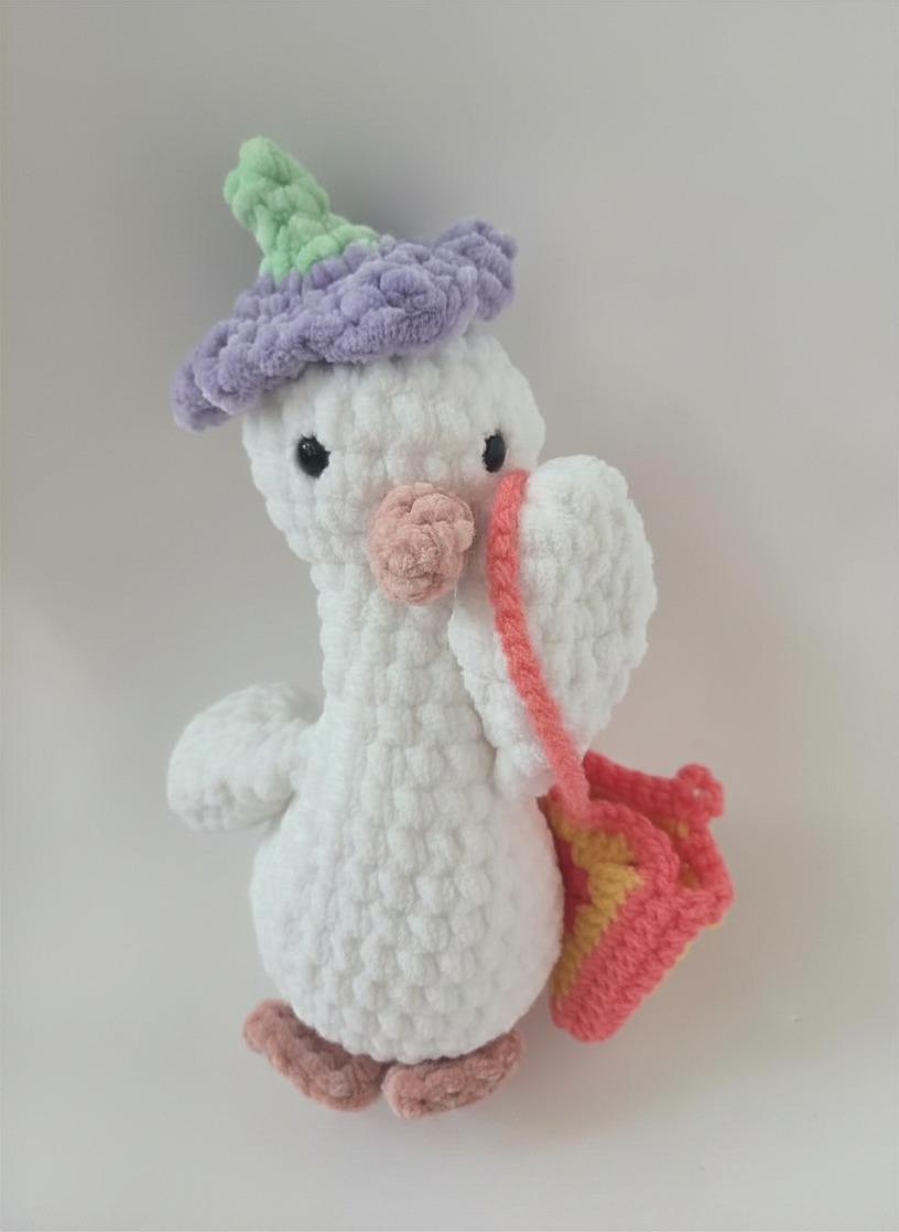 Crochet goose carrying a little purse