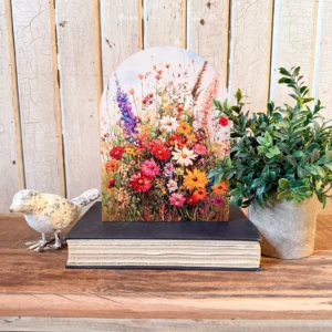 Arched Floral Sign Sitting on a Book