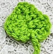 Bookmark: strawberry, crocheted. Bright red strawberry, tiny white "seed" details. Grass green leaf and stem.
