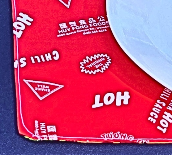 Reversible BBQ placemats; set of 4; sriracha sauce pattern on one side, grill flames on reverse side.