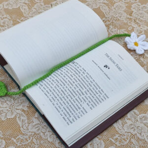 Crocheted bookmark, white daisy with delicate yellow center, pretty green stem & leaf on the end.