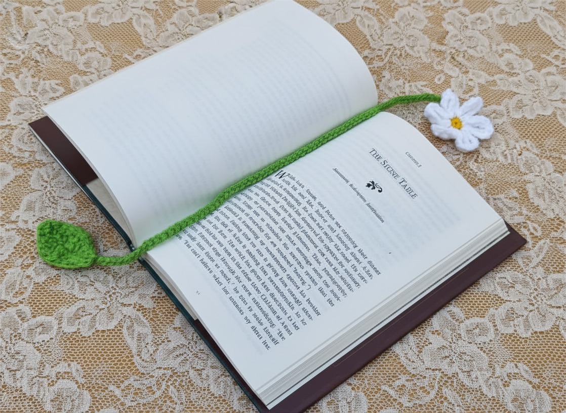 Crocheted bookmark, white daisy with delicate yellow center, pretty green stem & leaf on the end.