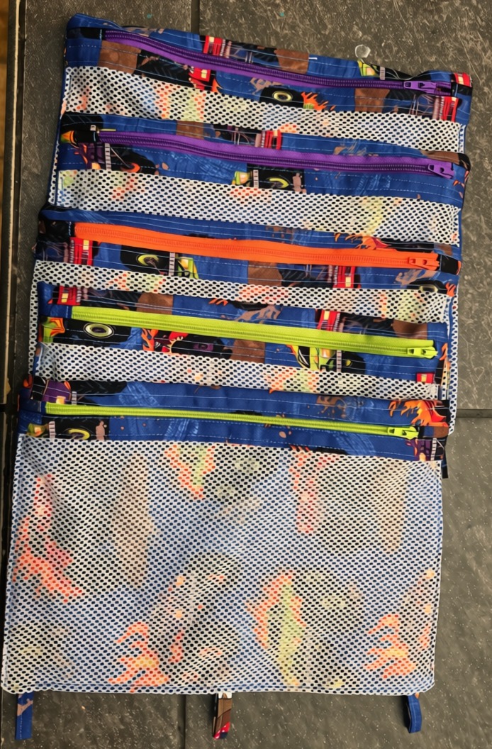 Monster Truck pencil case, fabric, zip closure, mesh front. Available with 3 zipper colors: orange, purple, or lime.