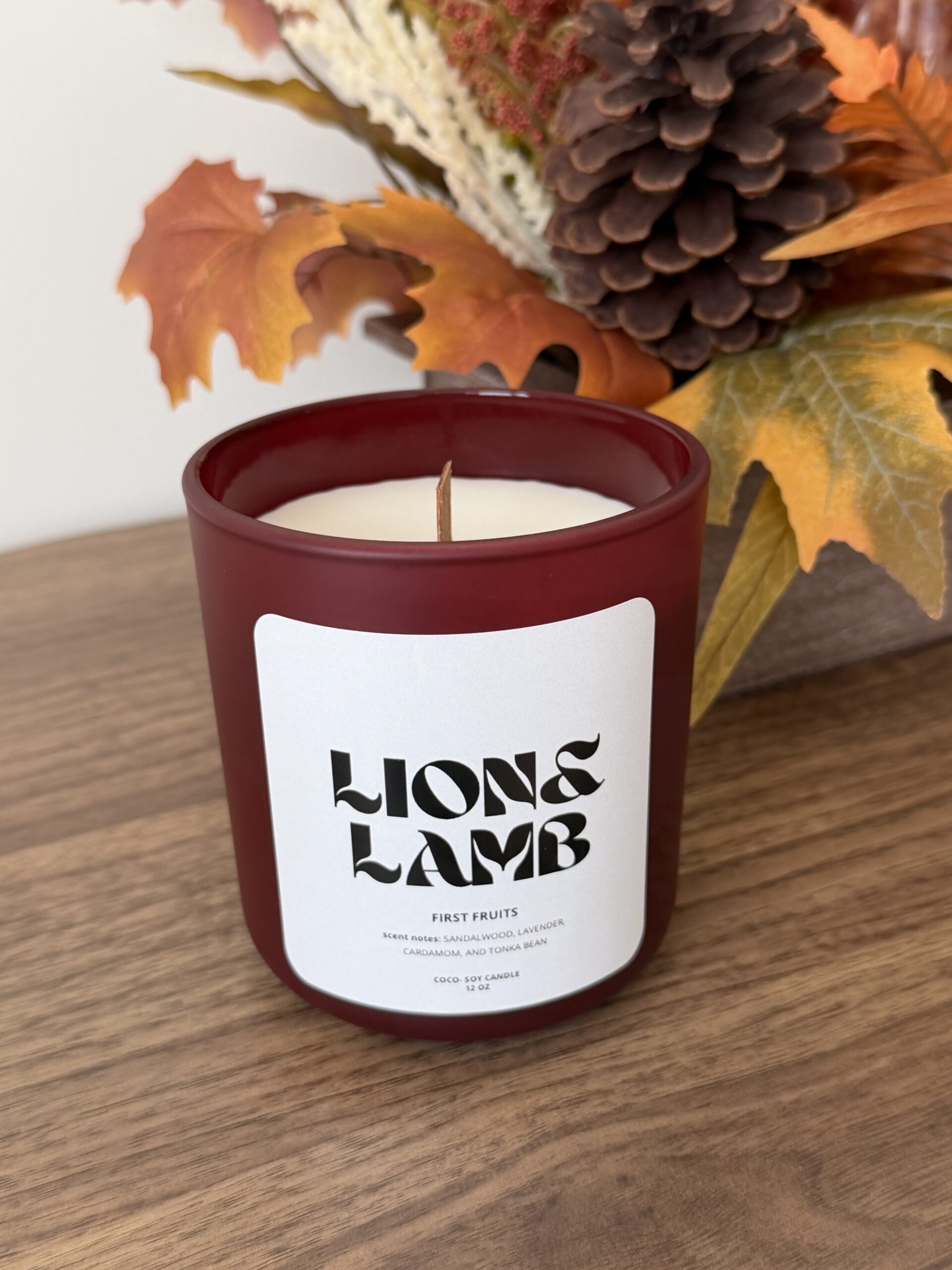 12 oz First Fruits coco-soy candle with a wooden wick in a wine jar