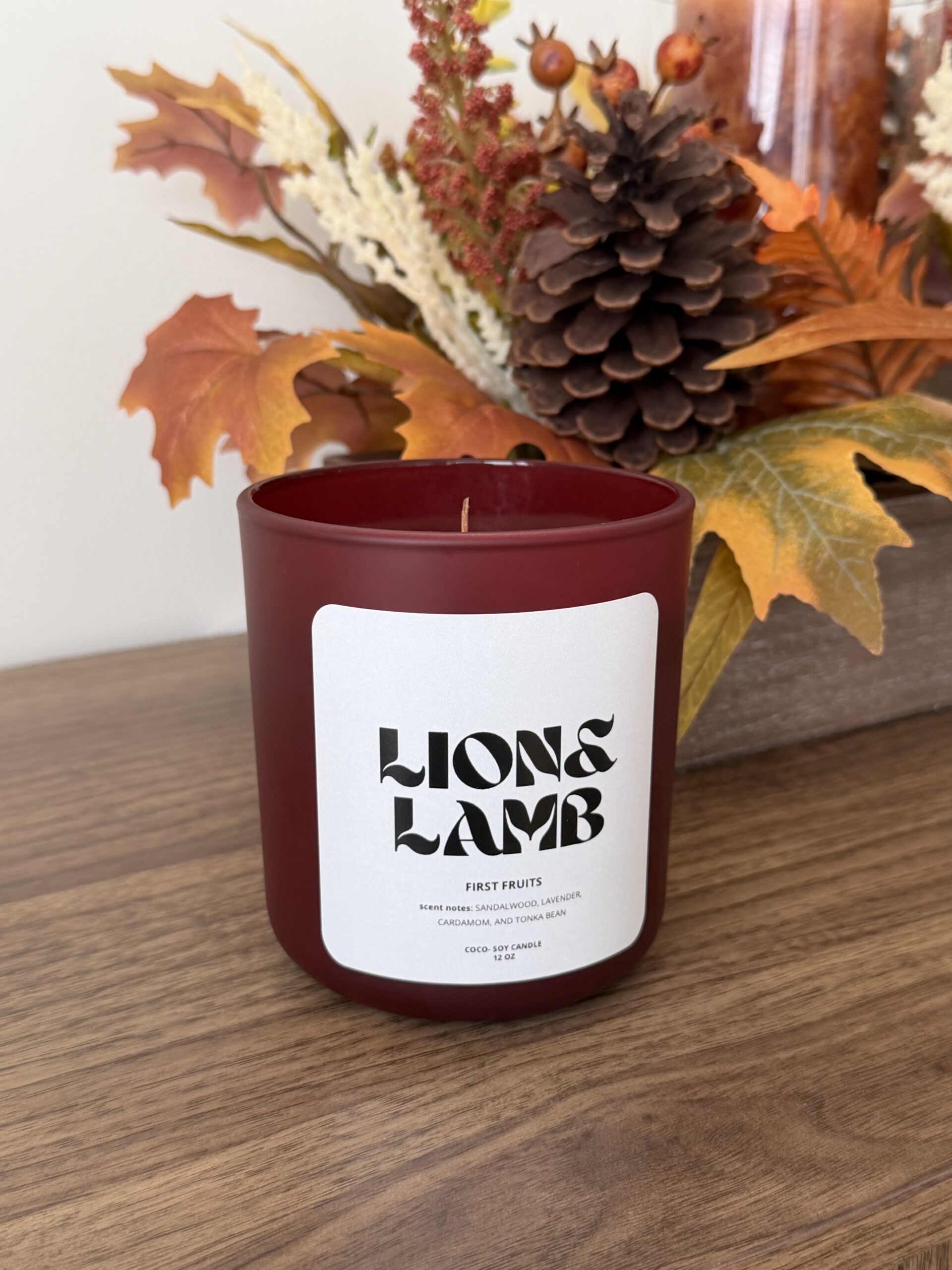 12 oz First Fruits coco-soy candle with a wooden wick in a wine jar