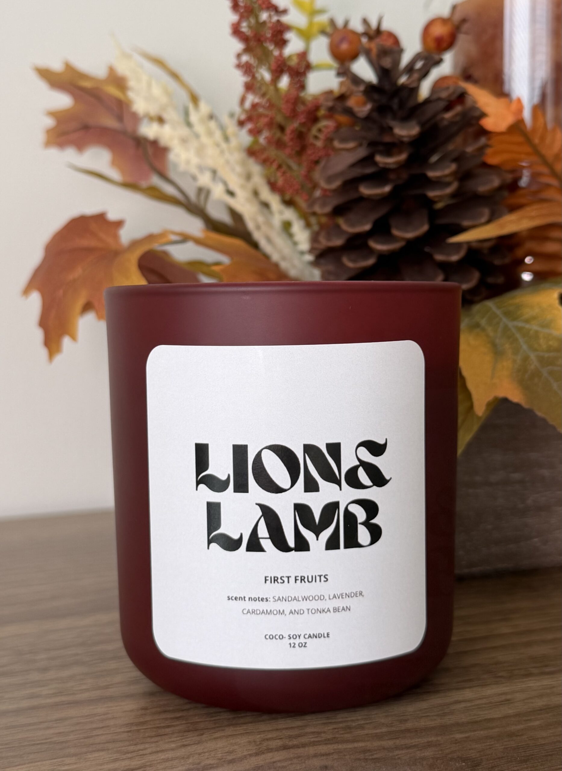 12 oz First Fruits coco-soy candle with a wooden wick in a wine jar